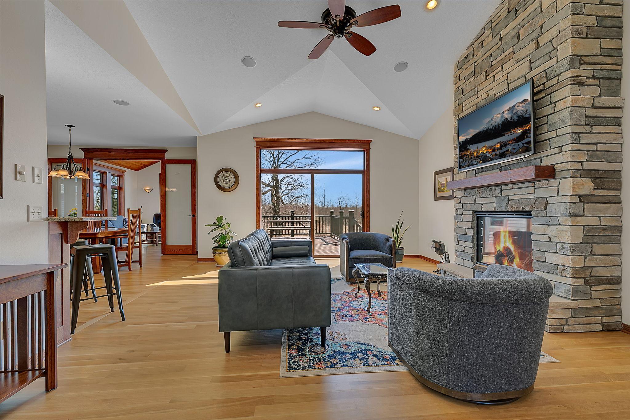 Step inside and be wowed! This home greets you with an open-concept layout, soaring windows, stunning floors, and a beautiful stone fireplace that anchors the space in style.