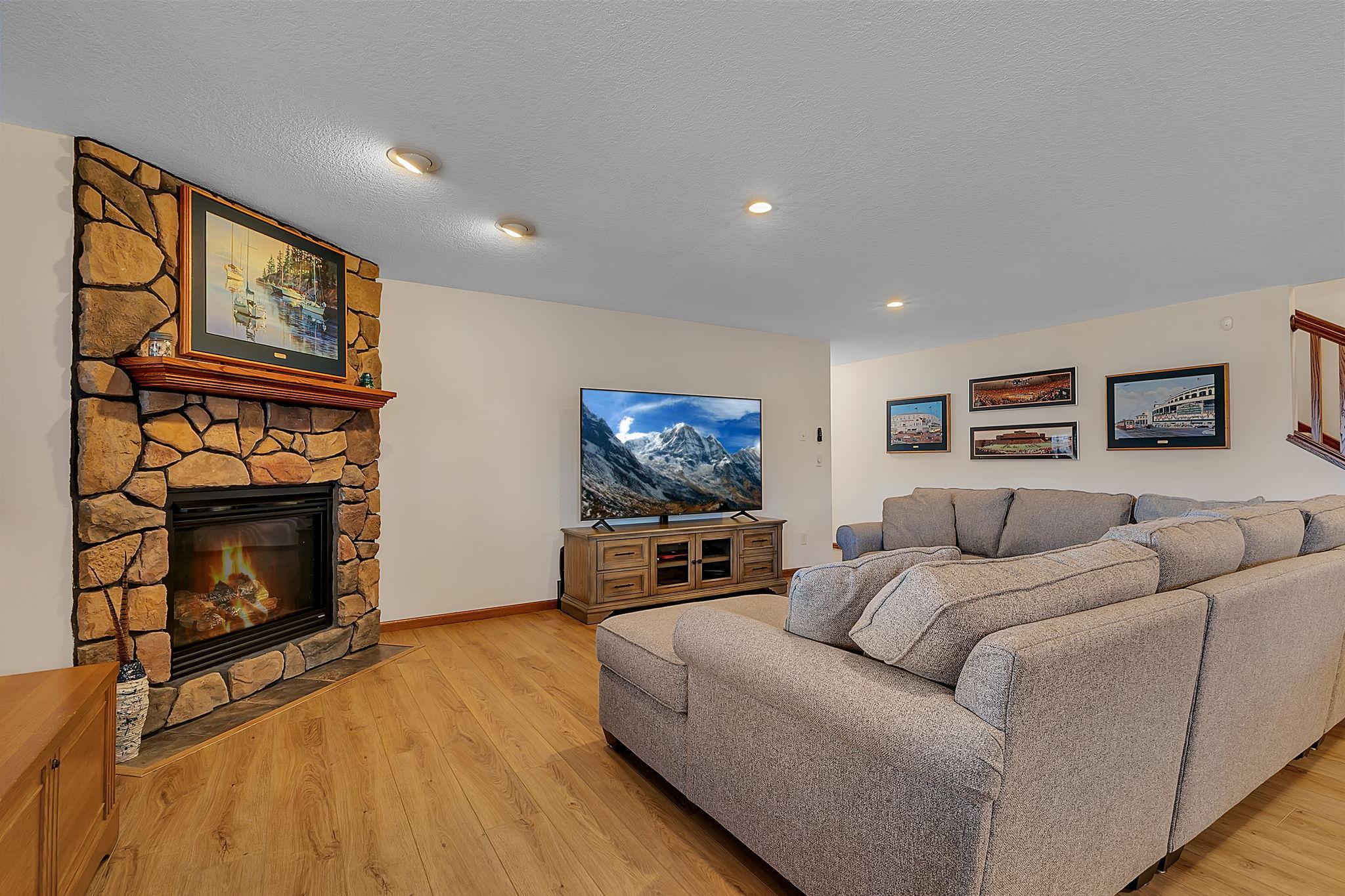 A spacious lower level living room offering plenty of space for multiple couches and seating arrangements. Great for hosting, movie nights, or simply spreading out and relaxing.