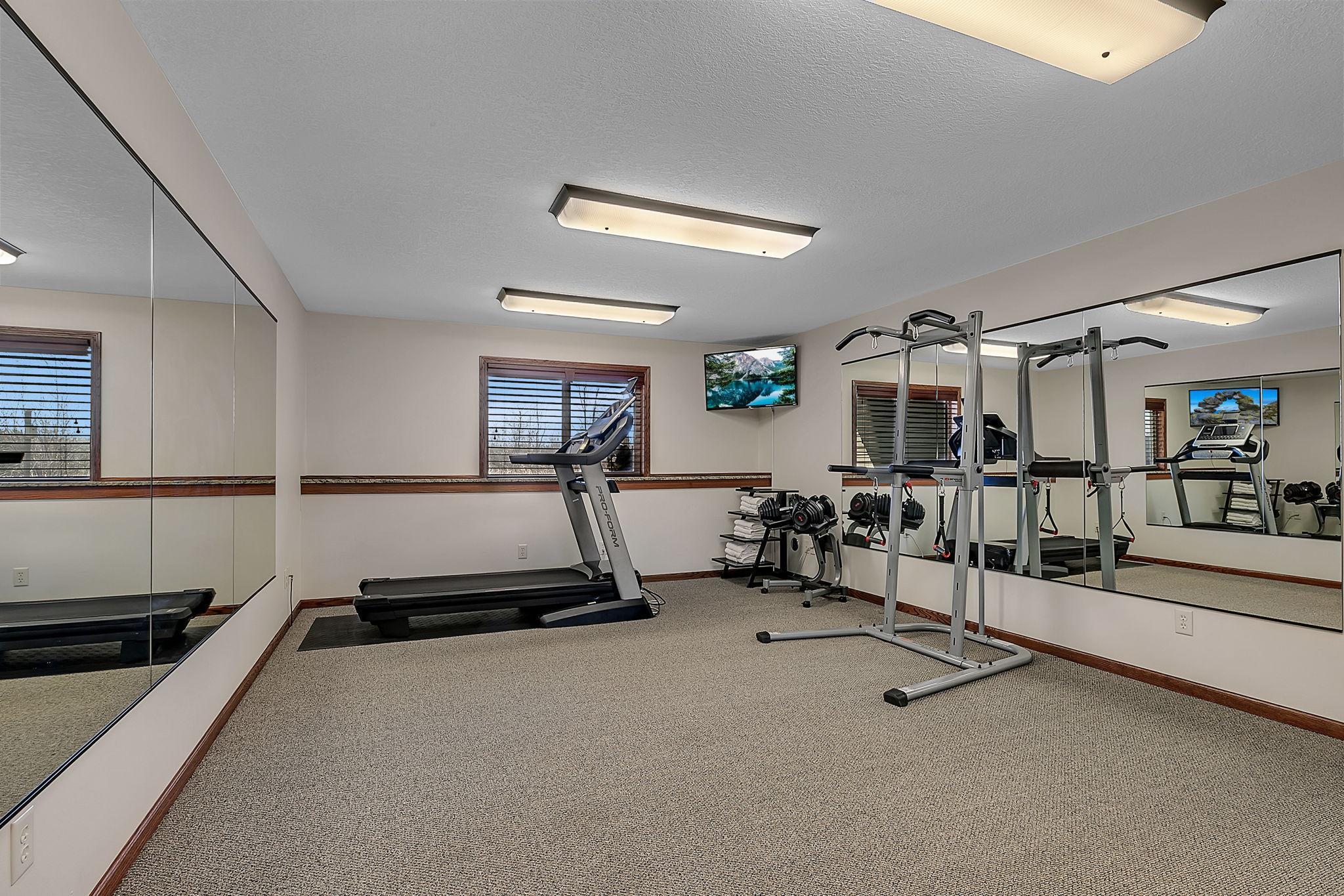 A generously sized fifth bedroom on the lower level, offering endless possibilities—perfect as a home gym, craft room, playroom, home office, or additional bedroom.