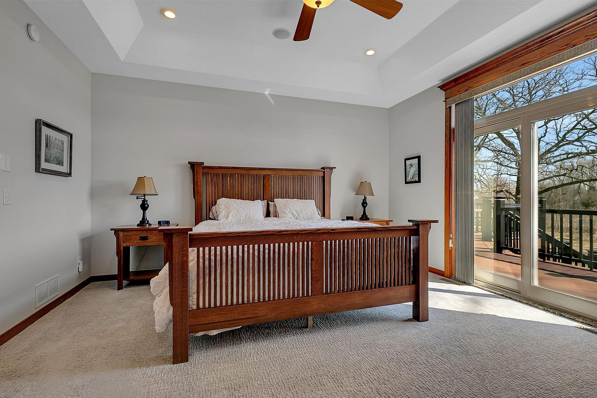 Another view of the primary bedroom, showcasing the abundant natural light streaming through the sliding glass doors.