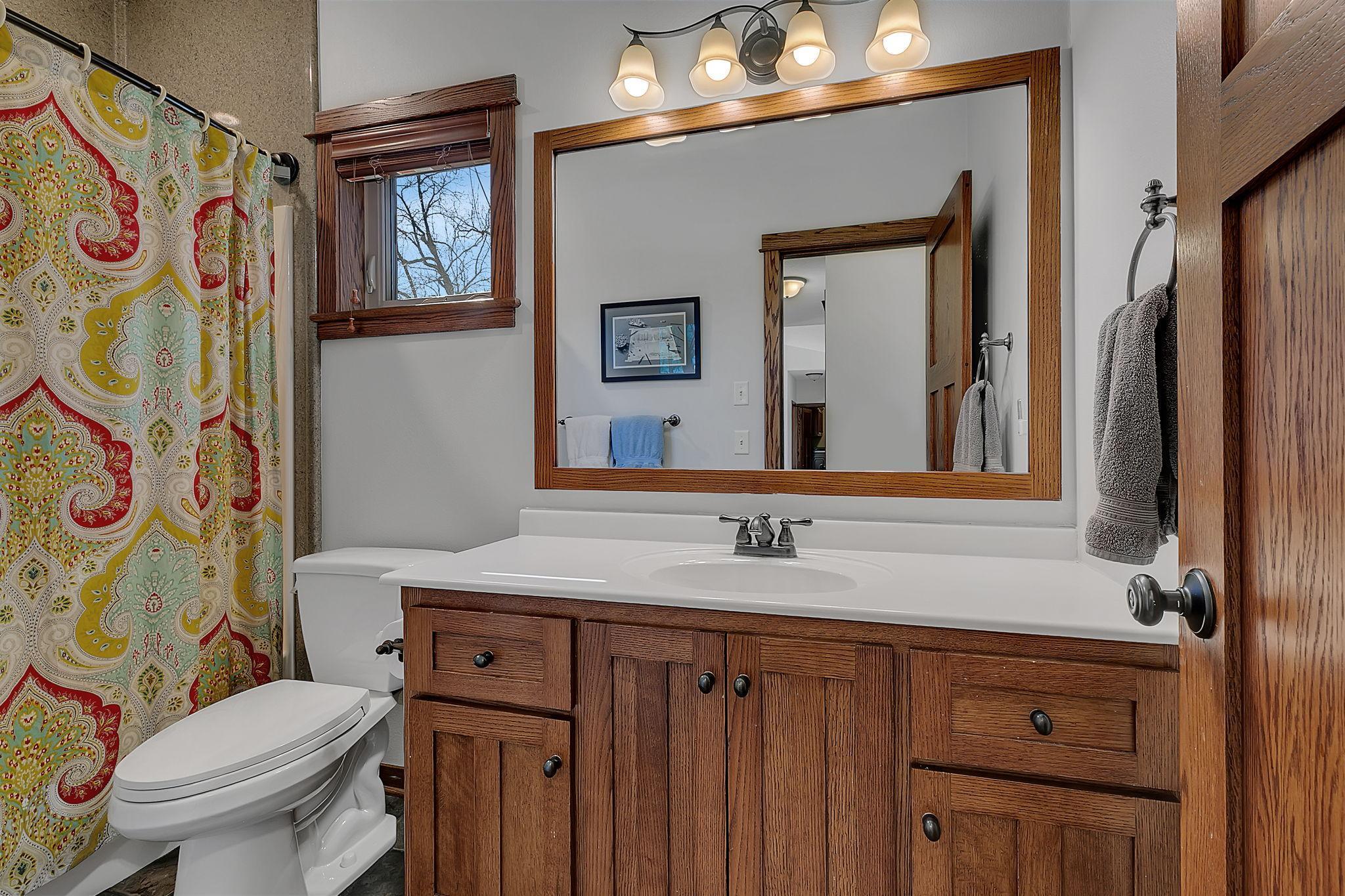 The general use main-level bathroom with tub and shower, plus a generous vanity for plenty of storage.
