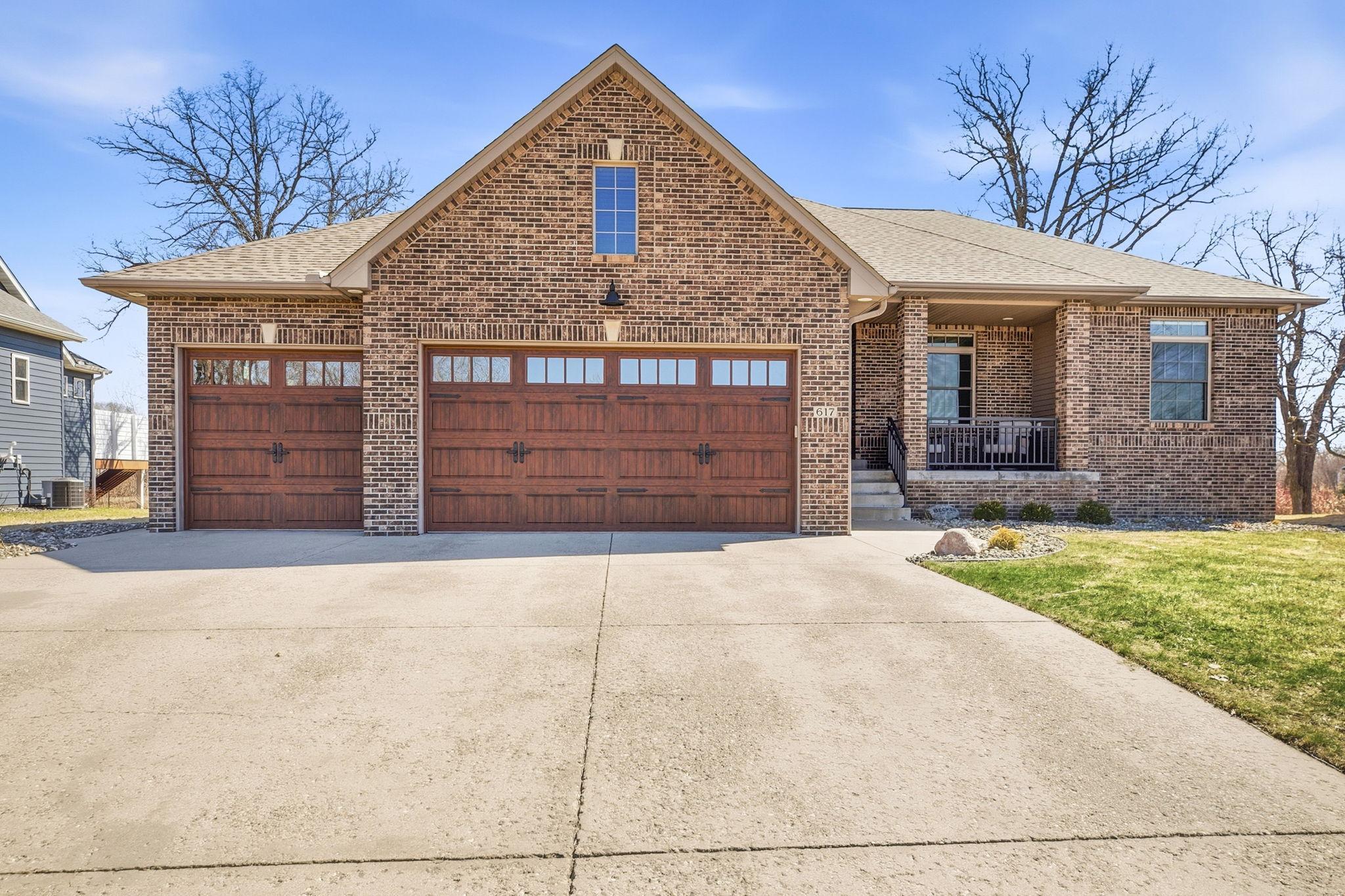 Beautifully crafted brick exterior with stylish garage doors, offering curb appeal and a welcoming entrance to the home.