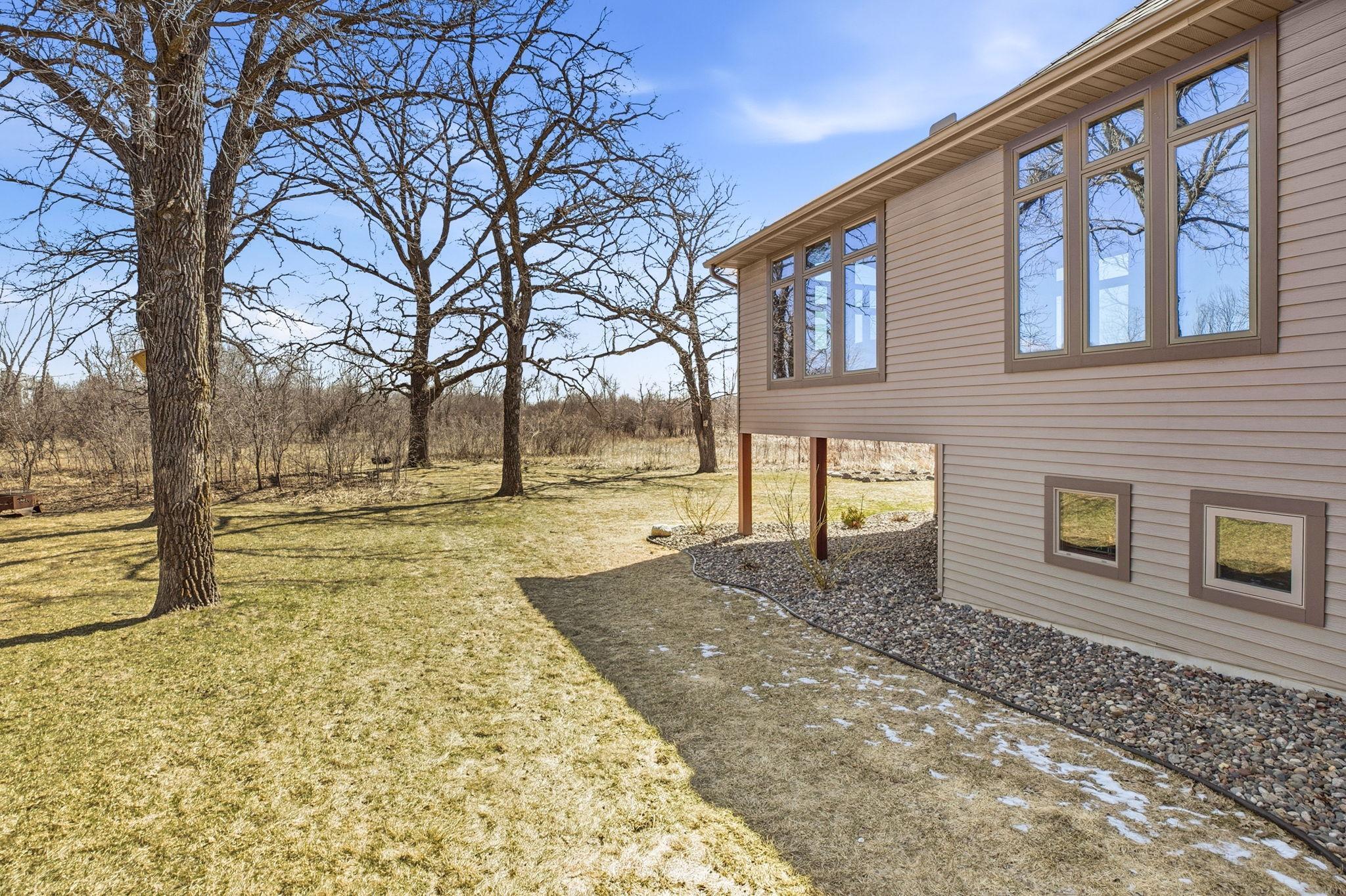 The property boasts mature trees, offering a peaceful, private, and picturesque outdoor setting.