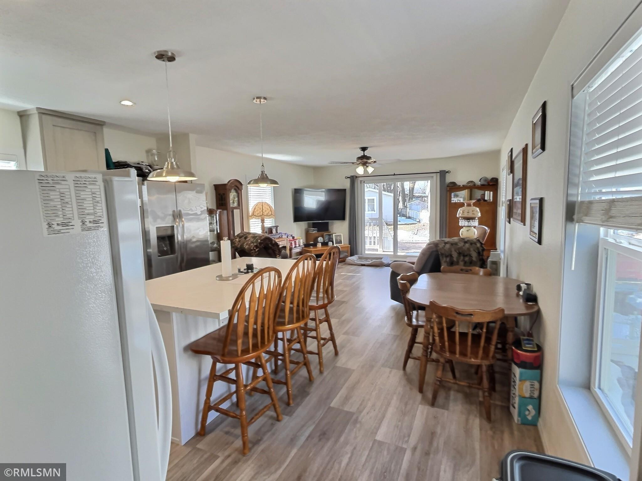 This shows the opposite angle of kitchen highlighting open concept living.