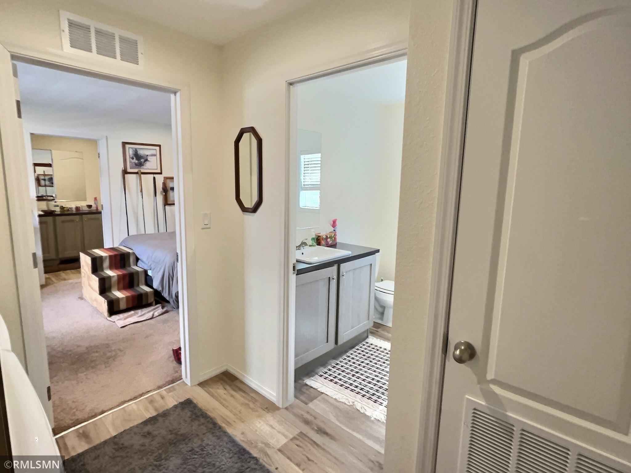 This shows the entry to second full bath located between the primary and second bedroom.