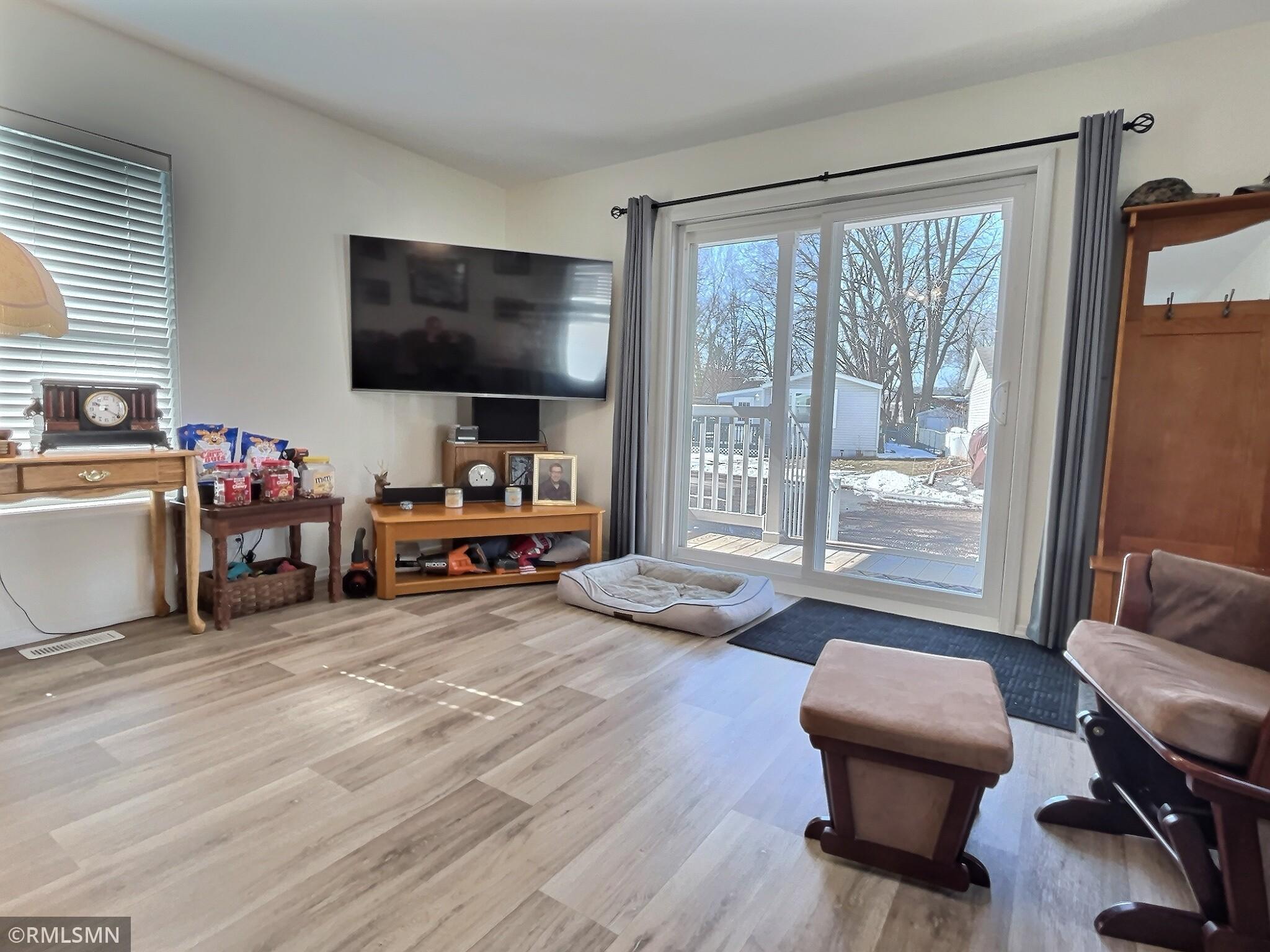 Another view of living room which showcases the view out the sliding door.
