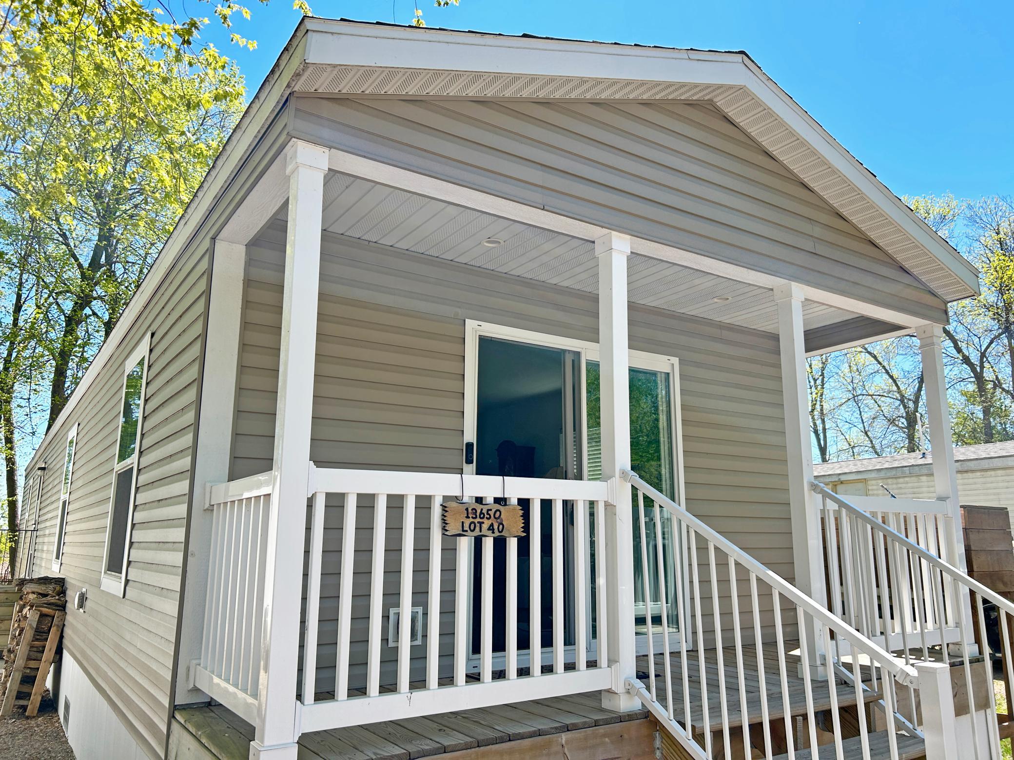 This 2022 manufactured home offers a beautiful front deck with access from the sliding door.