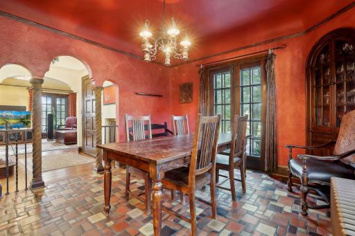 Dining room with vintage tile floor and pillars.