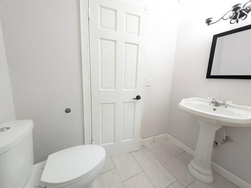 Conveniently located half bath, perfect for guests and everyday functionality.