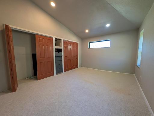 Spacious primary bedroom with peaceful views of the surrounding acreage, offering a quiet place to unwind.