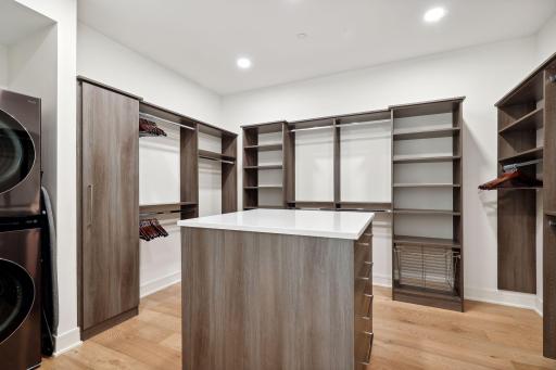 Amazing primary closet space with built-in components and laundry units