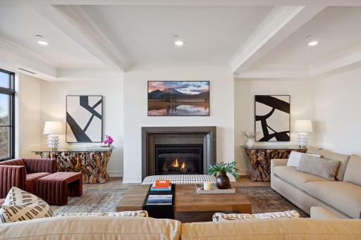 A handsome gas fireplace anchors one end of the living room