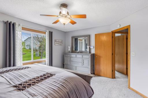 Spacious primary bedroom with neutral dÃ©cor and peaceful views of the yard.