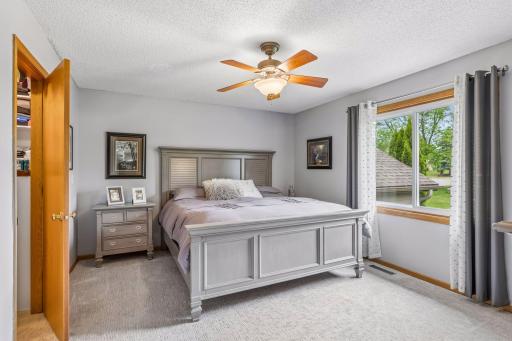 Generous primary bedroom with a ceiling fan, walk-in closet and large window letting in plenty of natural light.