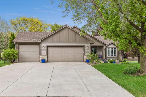Welcome to 8852 Rainier Drive, Woodbury MN. Enjoy driving on the upgraded concrete driveway that leads to the spacious 3-stall garage.