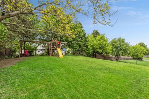 Kids will love the backyard playground with swing set and slide.