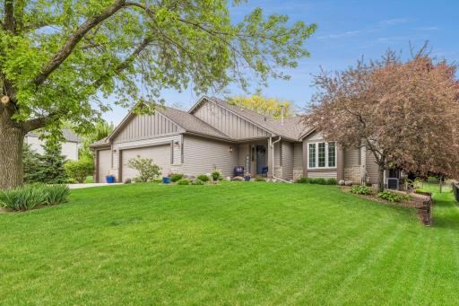 Stunning curb appeal on this .31 acre lot featuring lush grass and mature trees. New steel siding (2022), stone accents, and beautiful mature landscaping.
