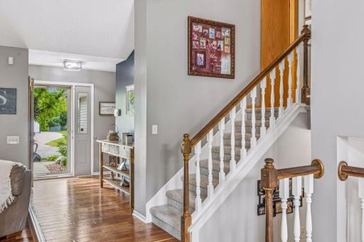 Step inside to a bright foyer with gleaming hardwood floors and an elegant open staircase.