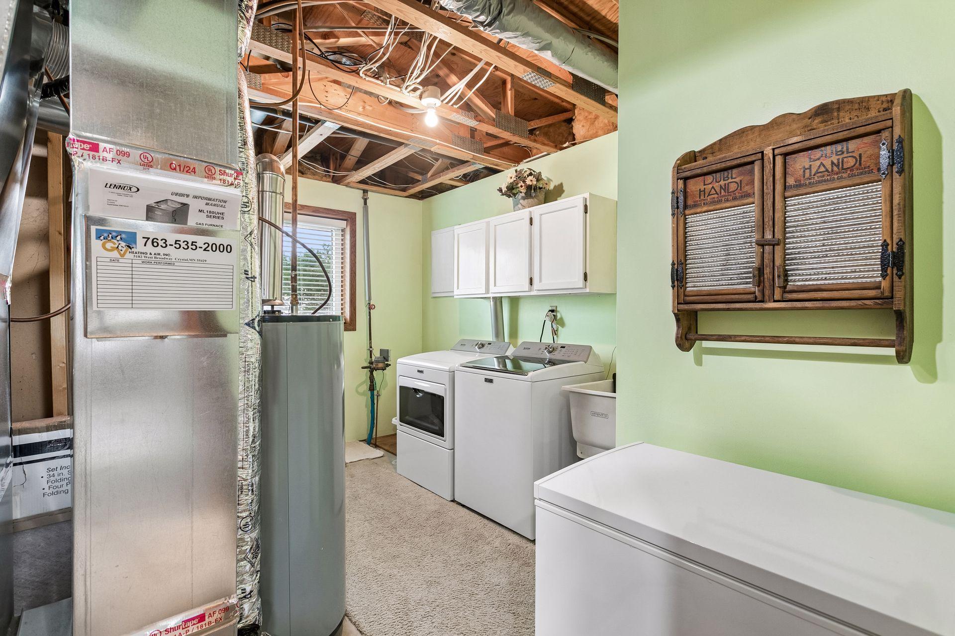 Laundry rooom is well appointed with sink and storage. New mechanicals in 2024 include FURNACE & A/C UNIT. Chest freezer stays with home.