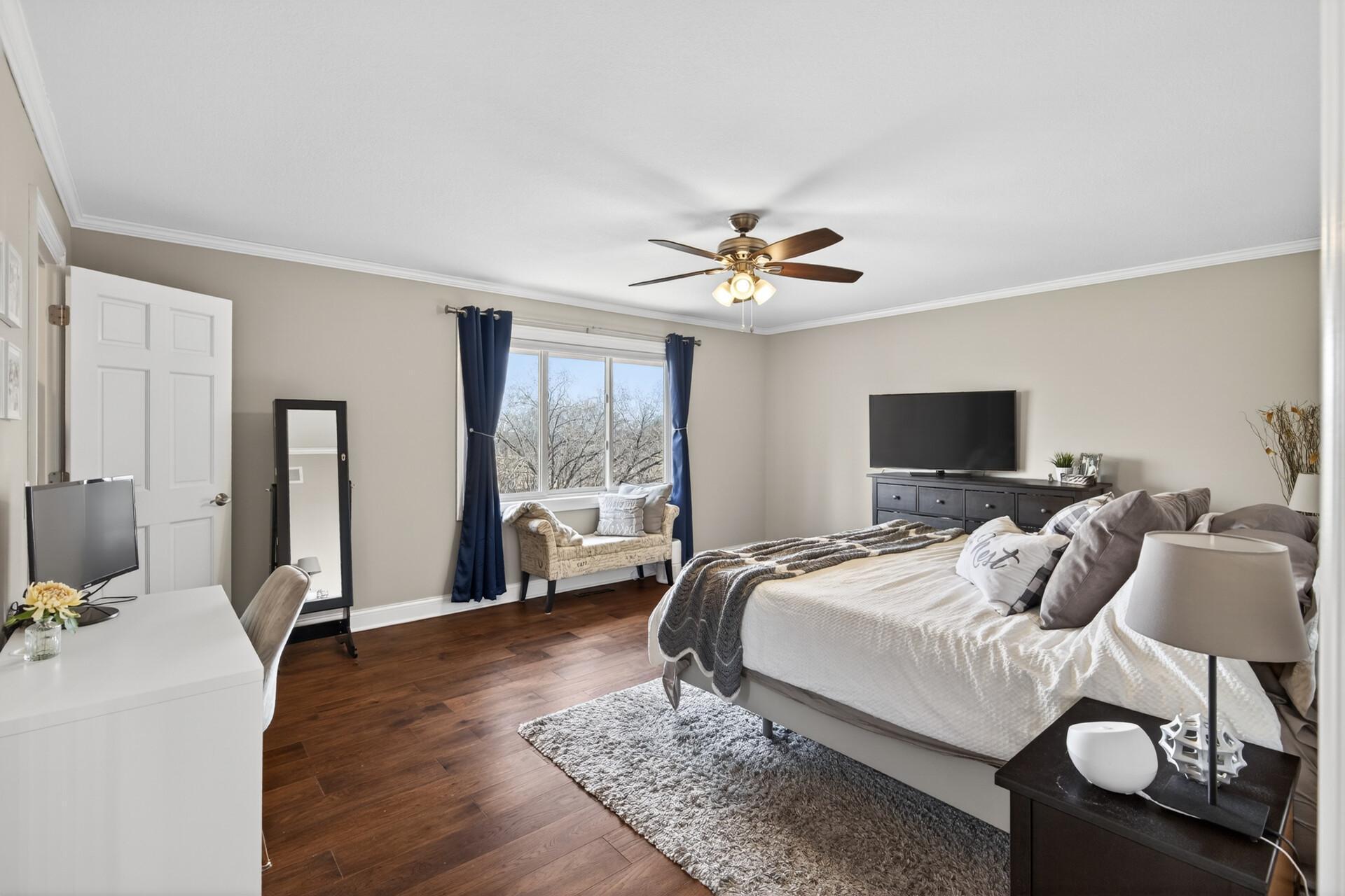 Primary suite with large 3/4 private bath and walk-in closet with custom built-ins