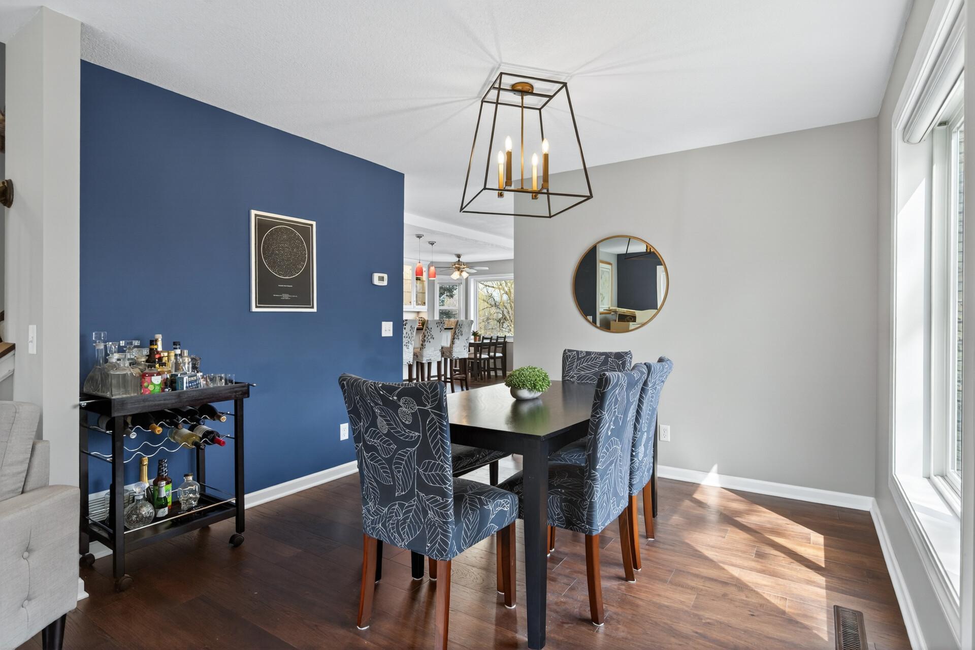 Formal dining room featuring a modern light fixture and large window