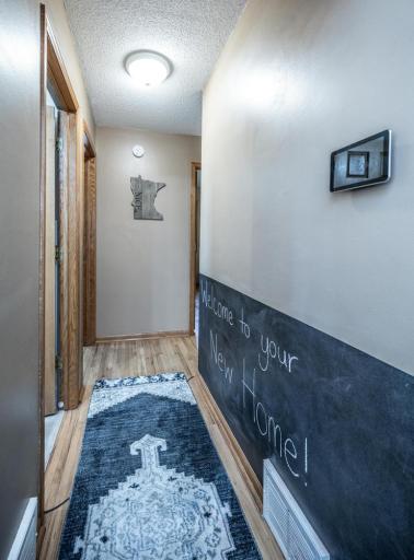Hallway leading to the full bathroom and 3 bedrooms