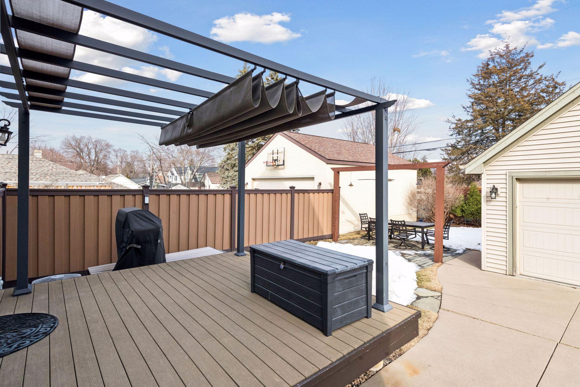 Wonderful back yard with a Trex deck, slate patio for dining plus great green space