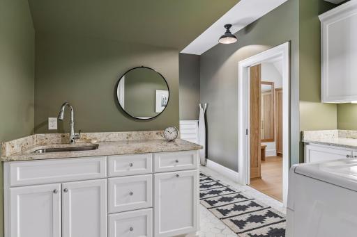 Laundry room with acess to primary closet