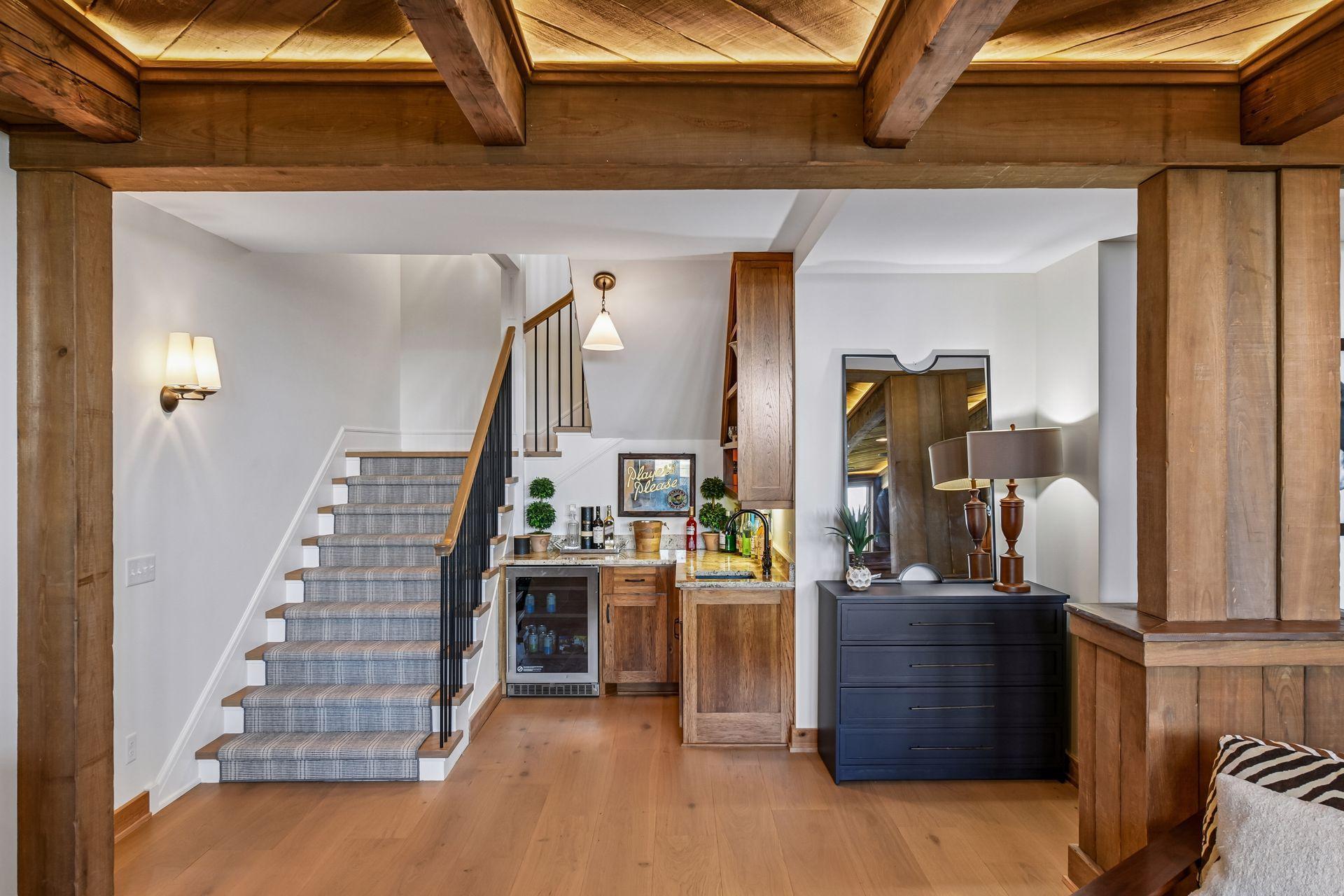 Built in wet bar with fridge in lower level family room