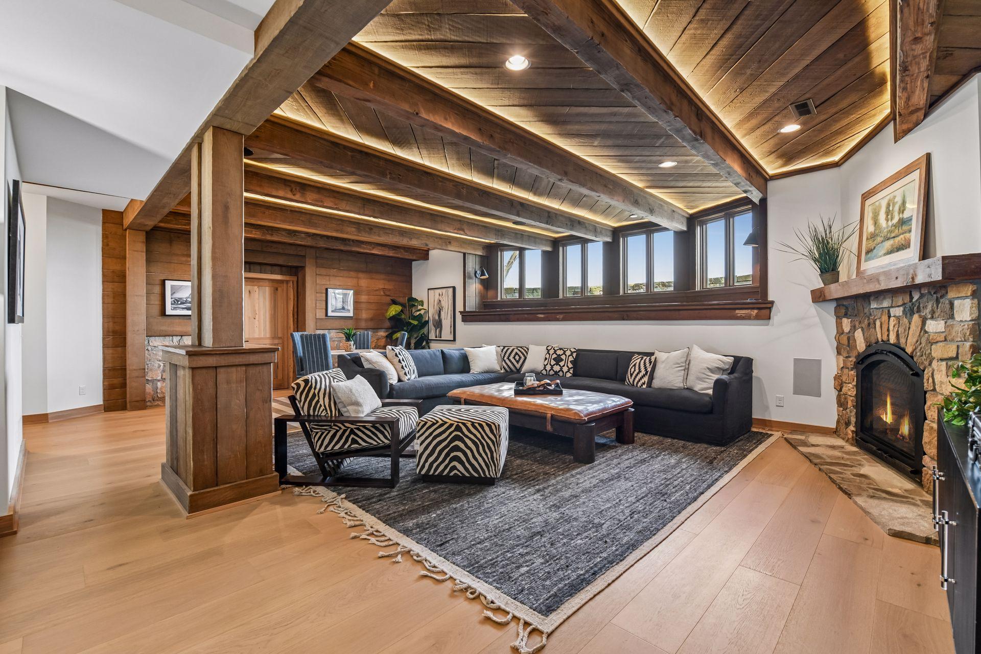 Large lower level family room with tall ceilings, lookout windows and fireplace