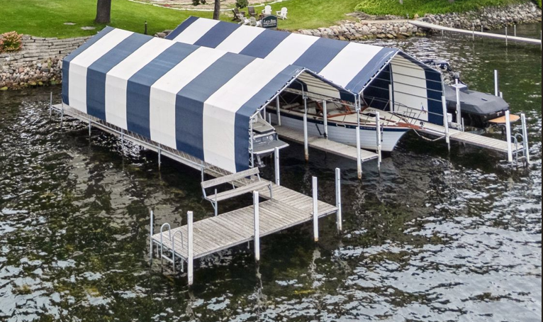 Dock with double cover slips and bench. This dock will be installed after 6/1. The dock at the property is excluded in the sale of the home