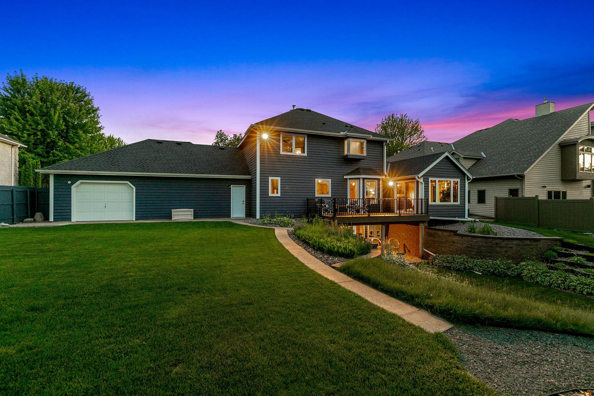 Intelligently designed landscaping and retaining walls facilitate the walkout elevation of the lower level and maximize the usable yard space.