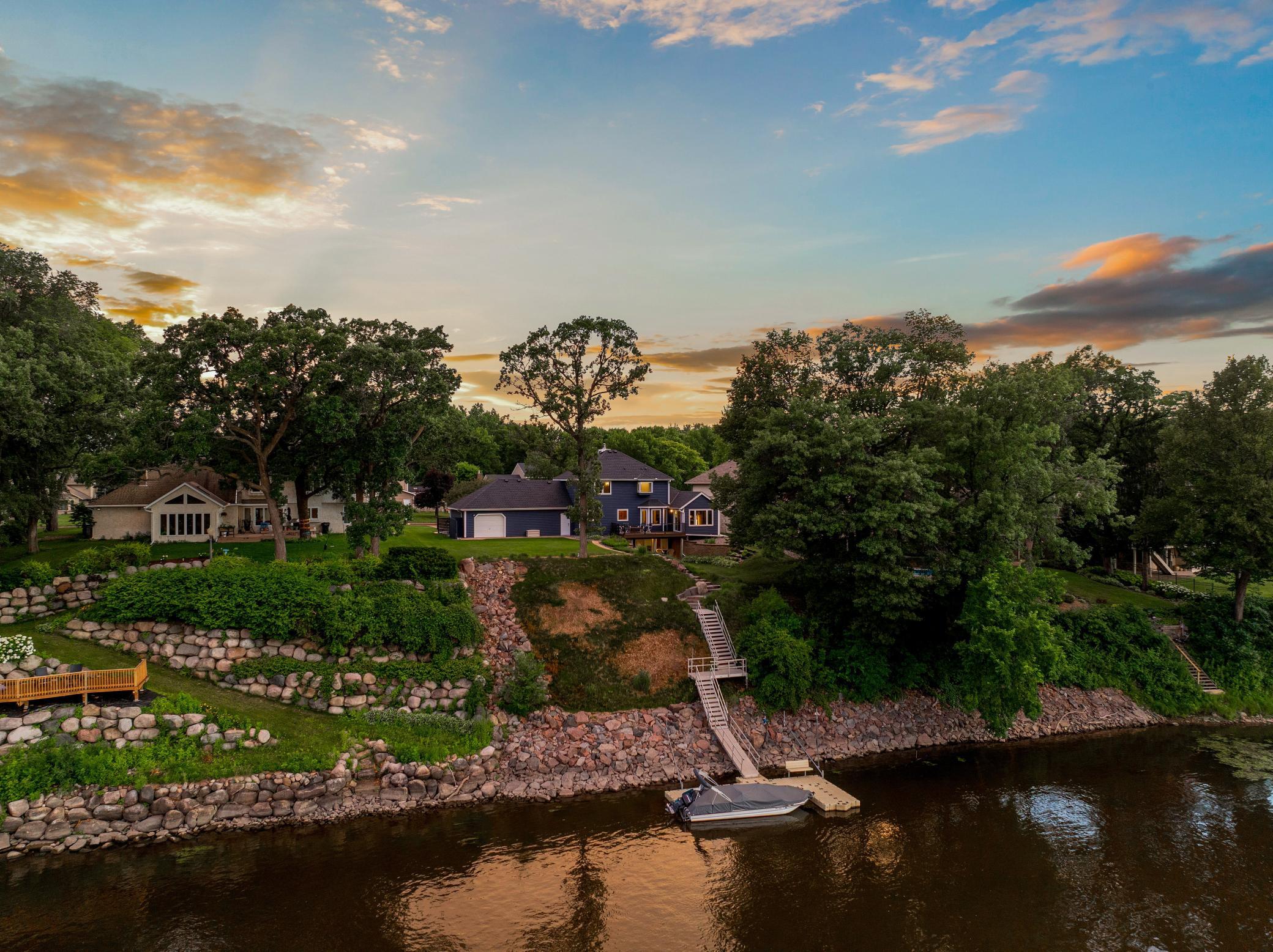 The shoreline renovation project features granite rip rap, granite stairs, an aluminum stair and platform system, poured footings for dynamic anchoring, and a maintenance free dock system.