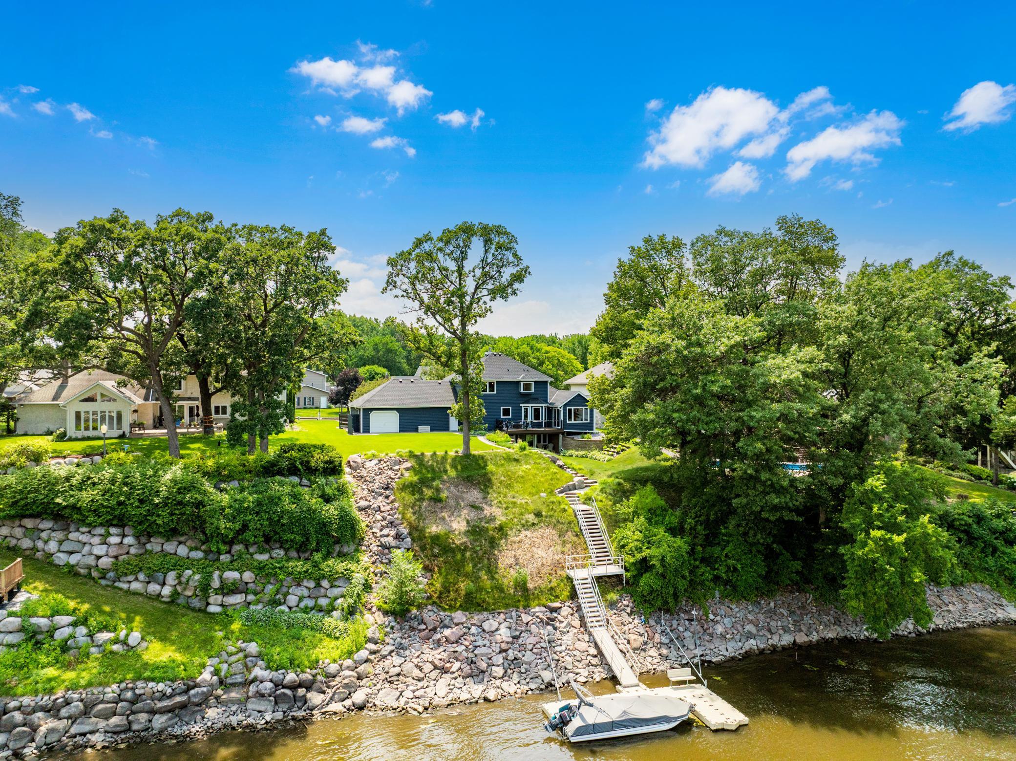 The 97 feet of Mississippi River shoreline has been significantly upgraded by the current owners with granite rip rap, erosion resistant fescue grass, landscaping, poured footings for dynamic anchoring/winching, and custom granite stairs.