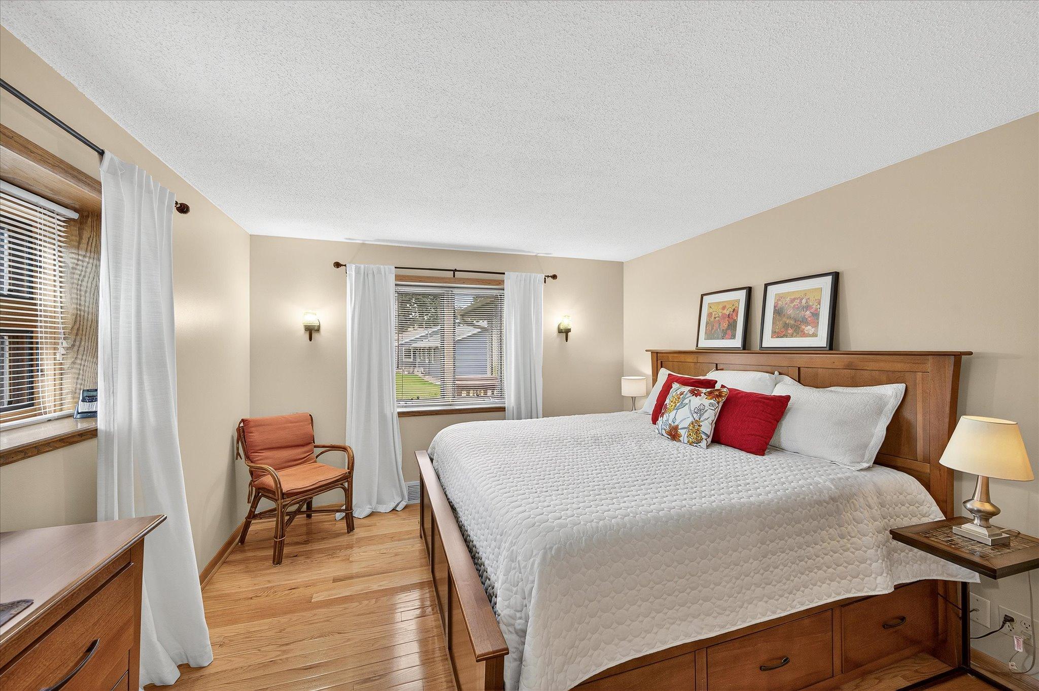 Primary bedroom suite with updated hardwood floors. Recently replaced wall sconces, not pictured.