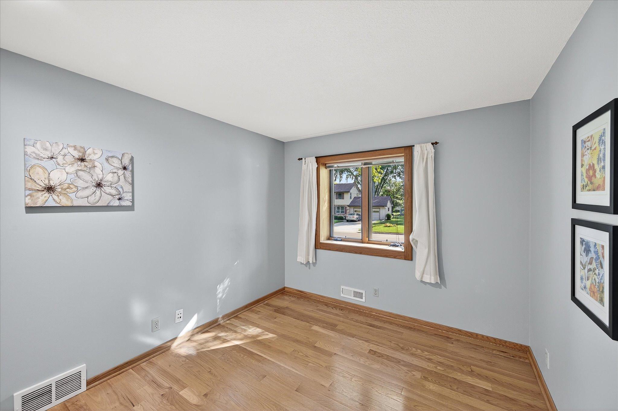 Bedroom 3 with hardwood and nice light, facing south. Floor has just been refinished.