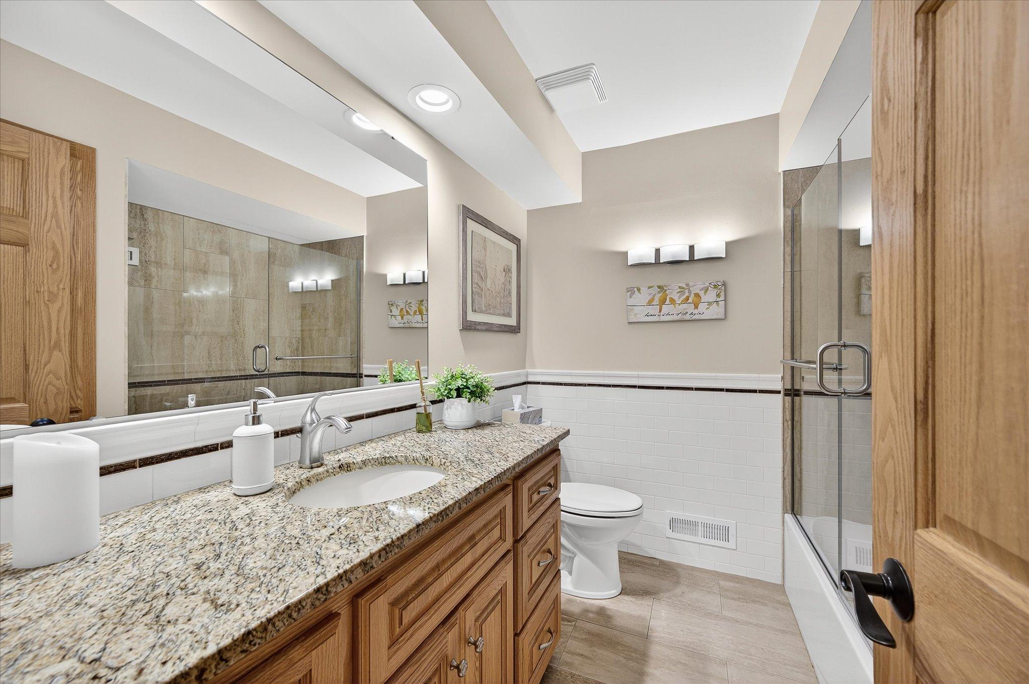 Totally remodel bath, custom cabinets, new bathtub with tile surround and tile walls and heated floor.