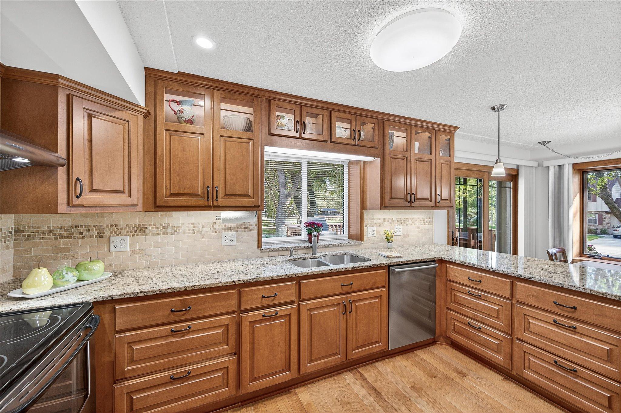 Custom cabinets with accent lighting in upper cabinets and undercounter lighting.