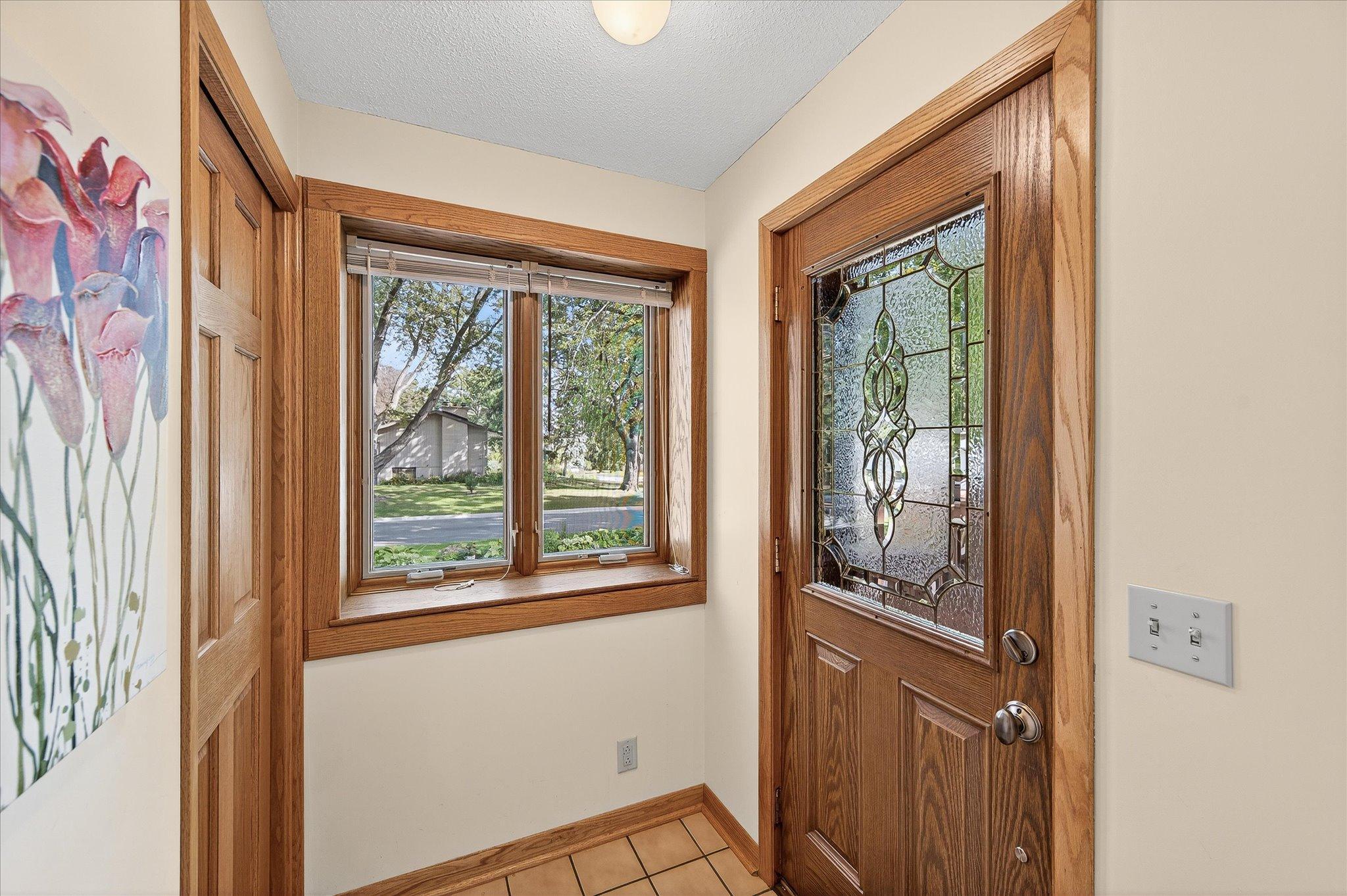 Front Entrance with a convenient closet and tile floors.