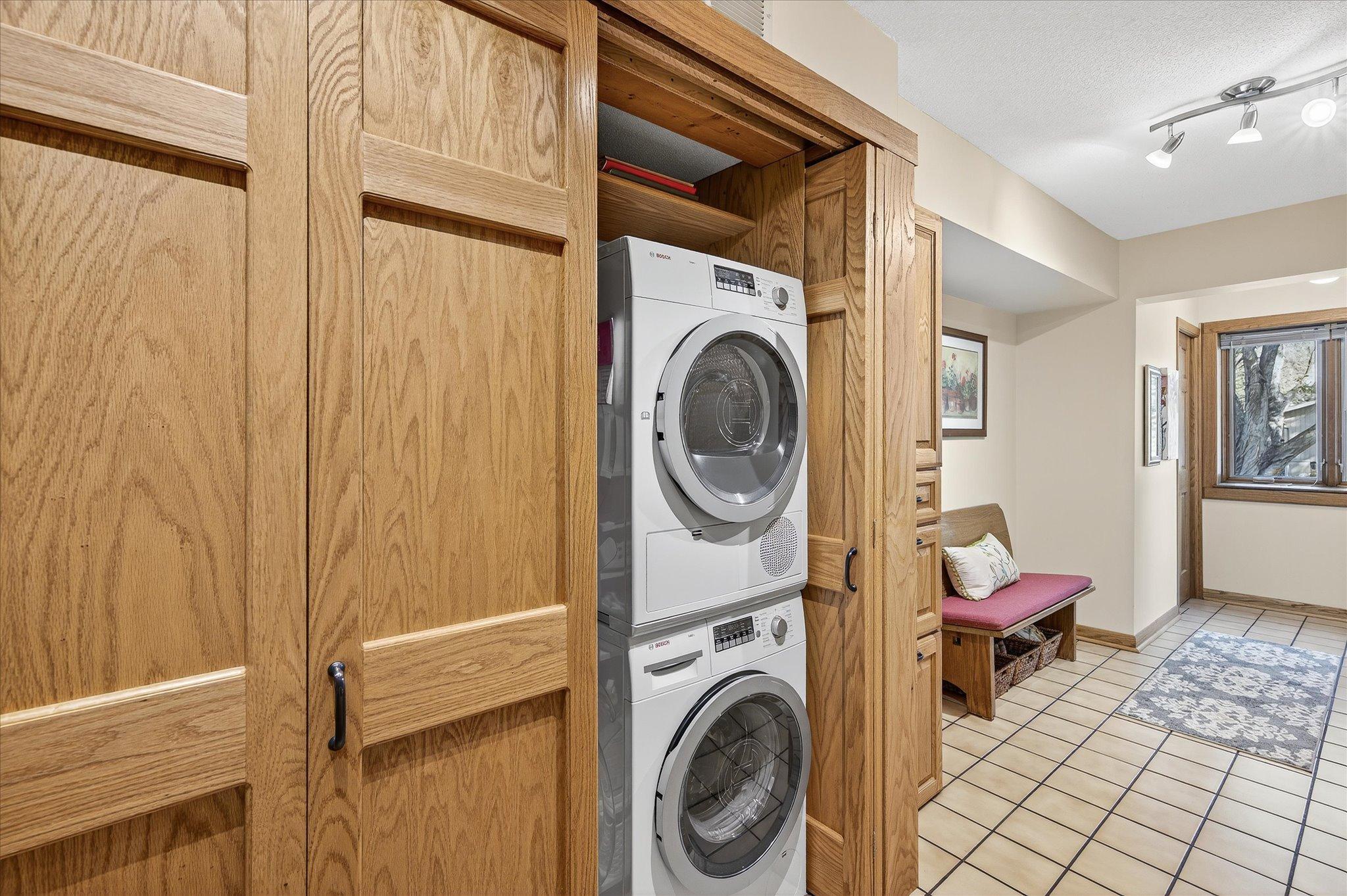 Main floor laundry in this closet with a special tuck in door that can hide the appliances, off the kitchen.