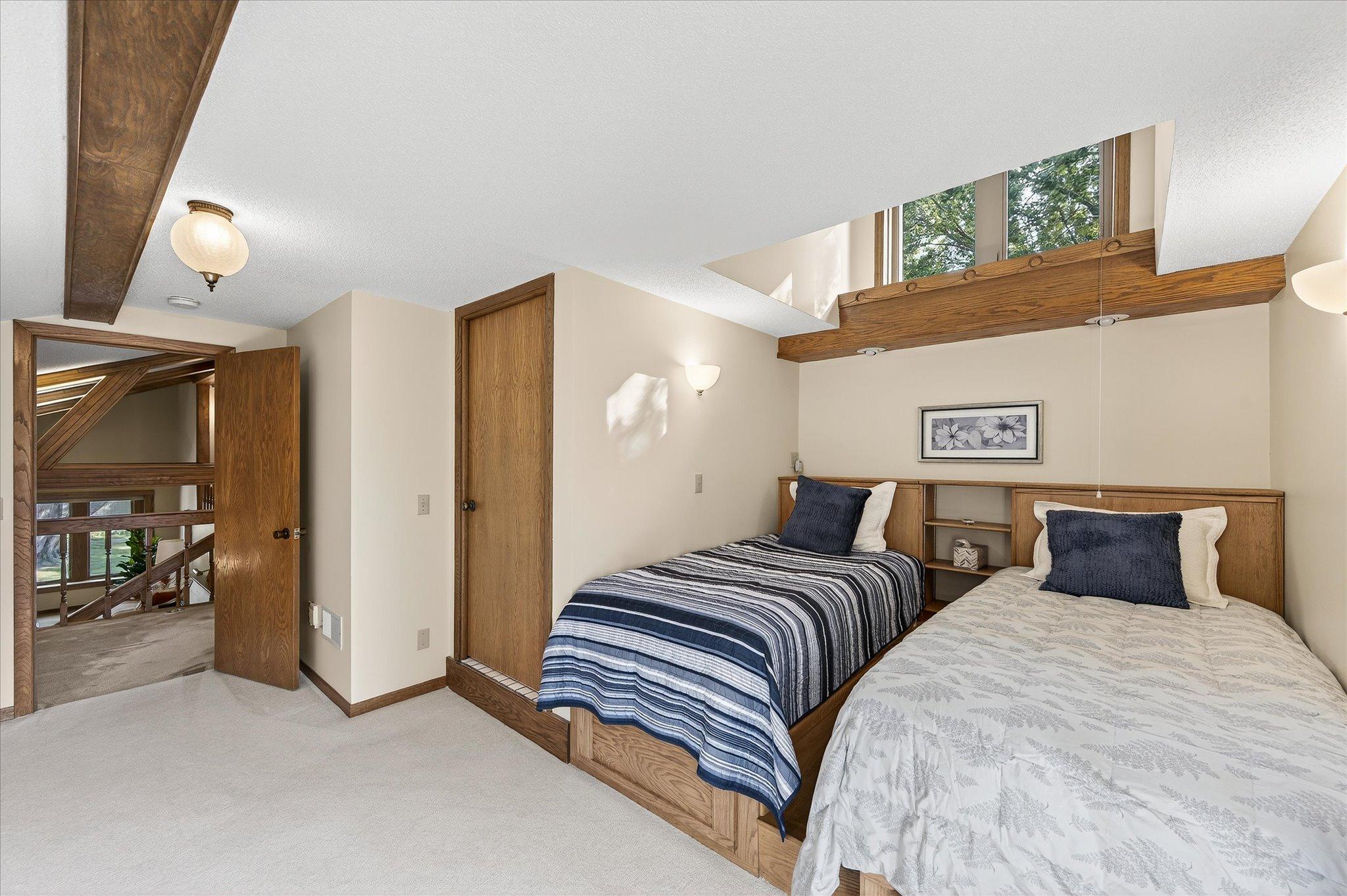 The bedroom upstairs off the balcony make this a private suite with bathroom. There is even extra storage drawers under the bed and in the headboards.