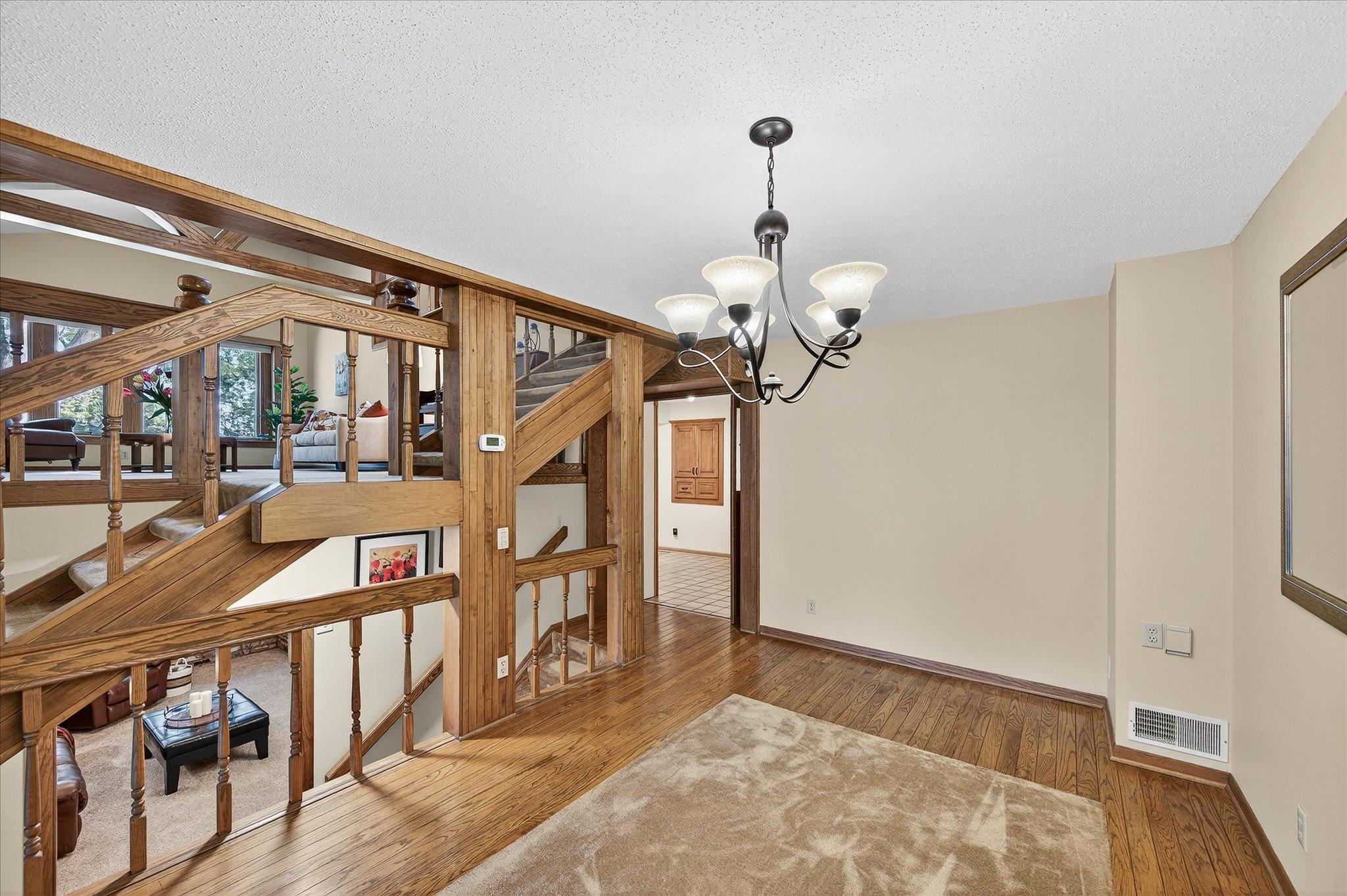 Hardwood floors with room for a large table and China hutch.
