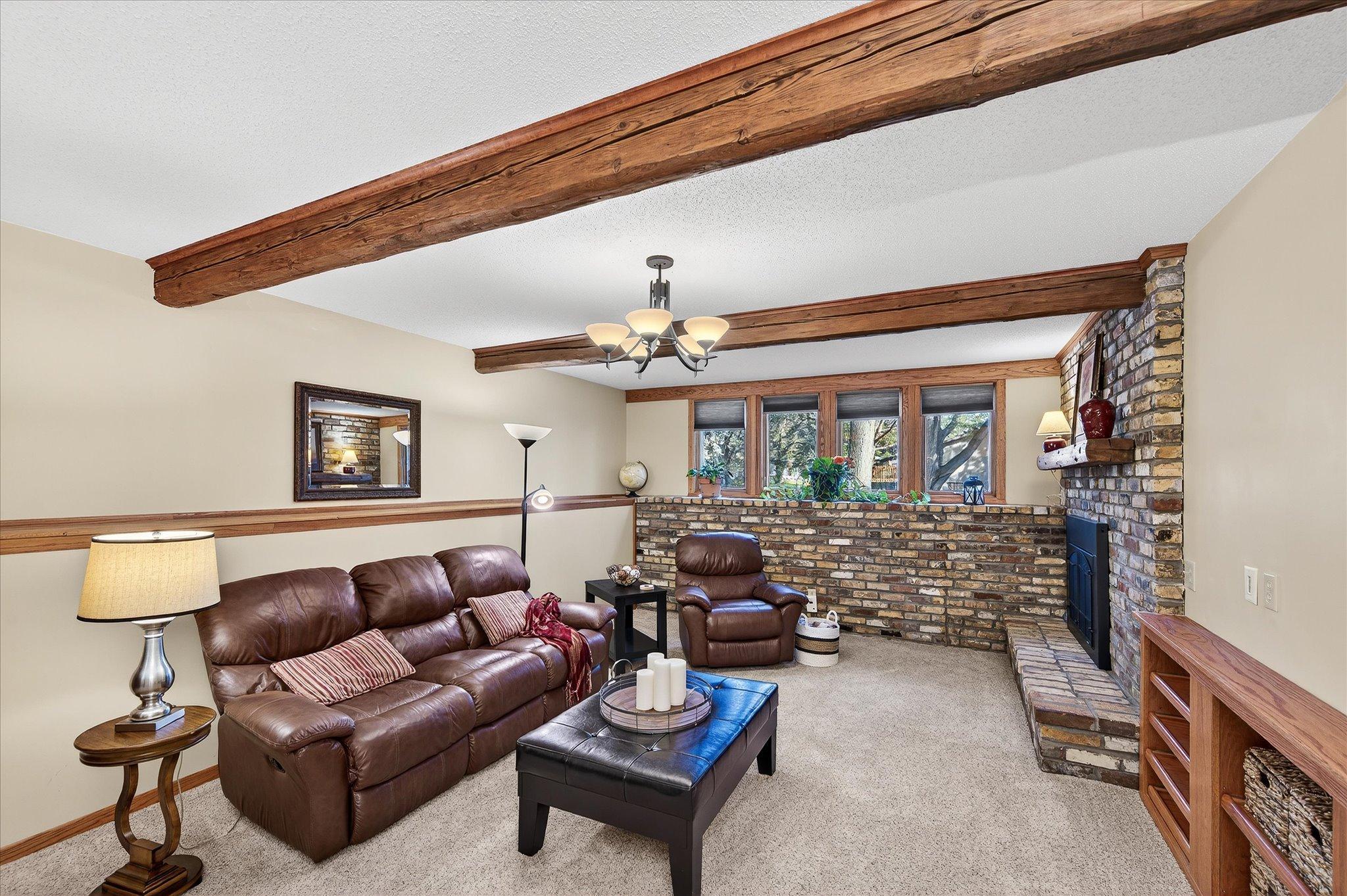 The Family room is a cozy room with a built in entertainment center and updated carpet. Beams are also from farm in northern Minnesota.
