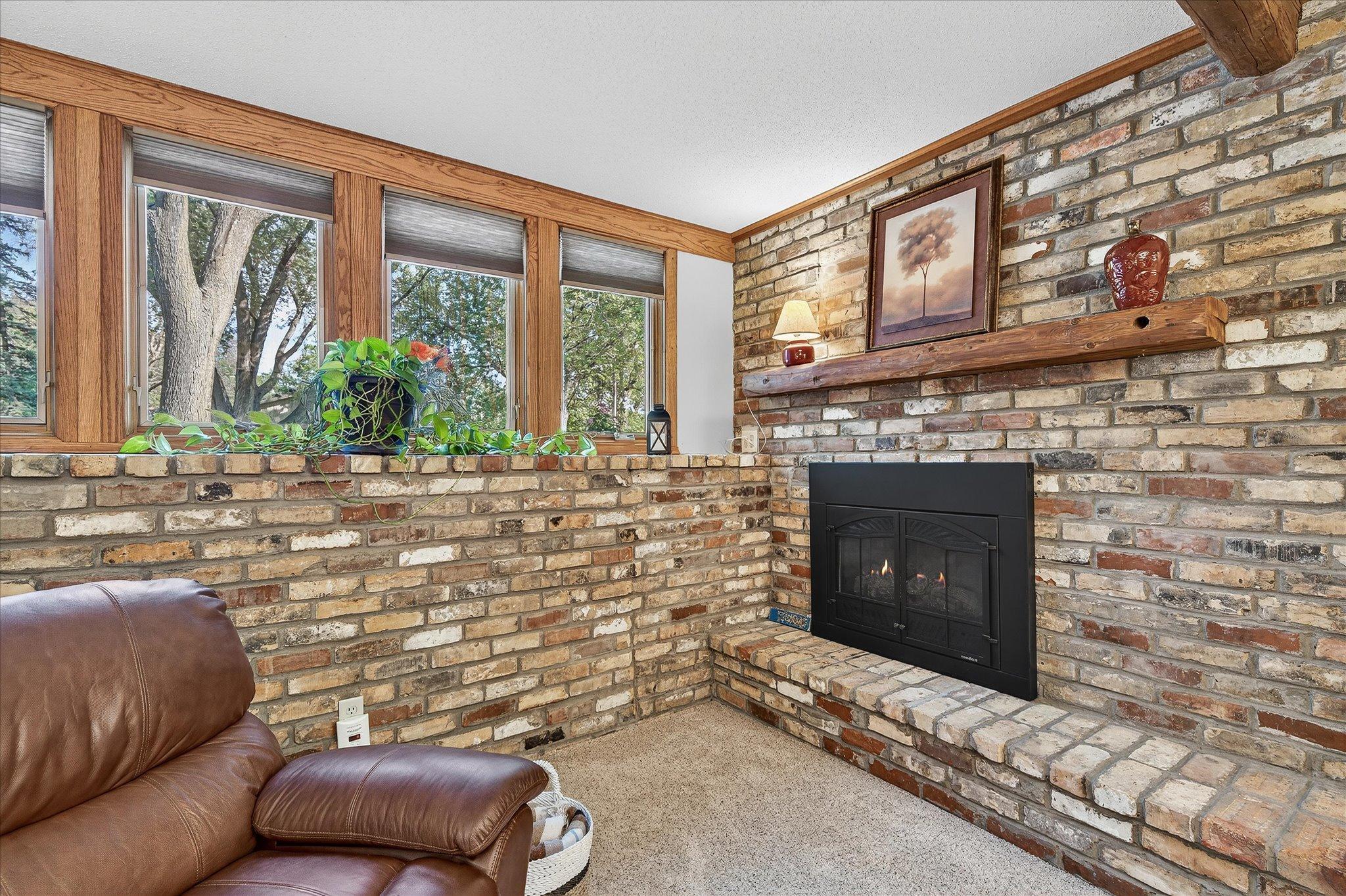 Brick surround and gas fireplace give the room a beautiful backdrop.