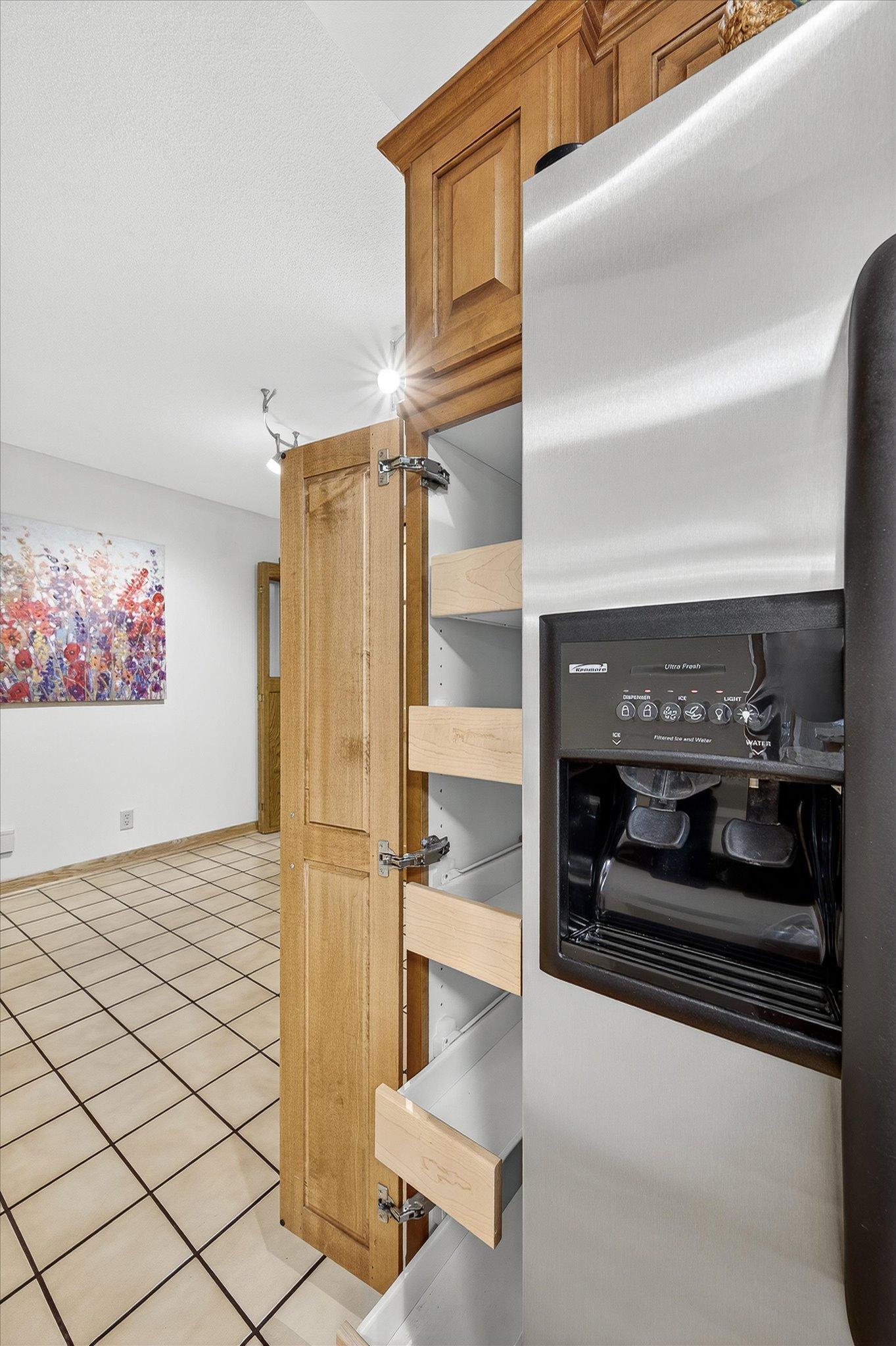 The kitchen leads to the entry where there is extra built in cupboards and laundry around the corner. The addition is through the entry.