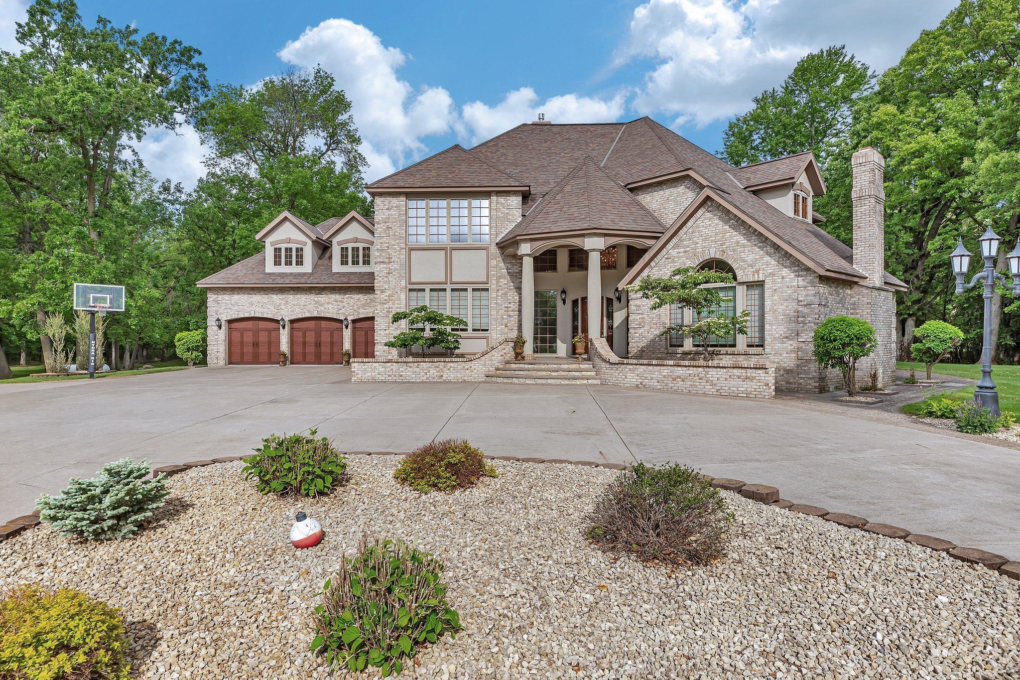 Lovely landscaping surrounds the home.