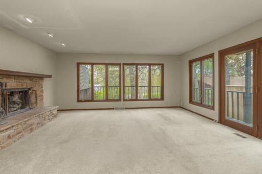 Living room features woodburning fireplace and lake views.