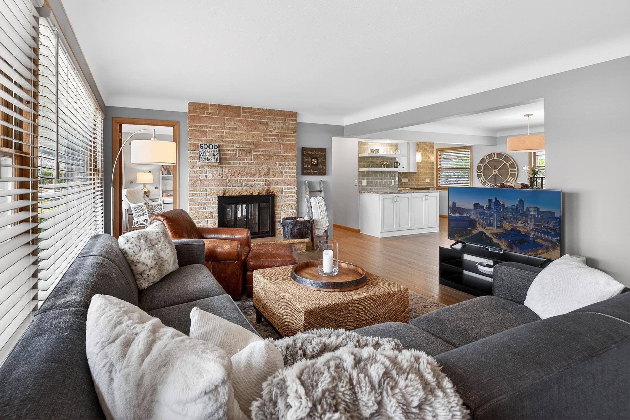 Living room with double-sided wood-burning fireplace...