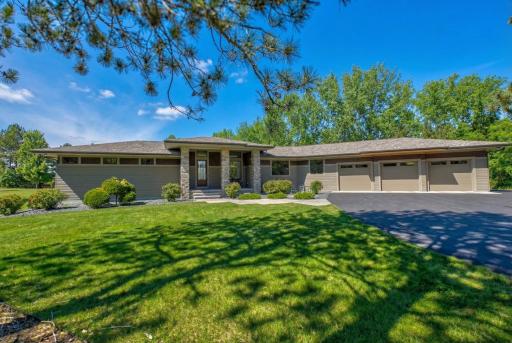 Additional highlights include an oversized heated and insulated 3-car garage with a sink and floor drain, an expansive mudroom with cabinetry and countertops, extensive storage throughout, and a home security system.