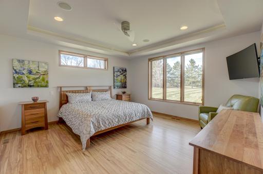 The ownerâs suite is filled with natural light and offers a spa-like bath with heated floors, double vanities, a walk-in shower, and a spacious walk-in closet with built-ins and in-closet laundry.